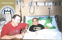 Andrew Rogers in the hospital with his dad by his side.