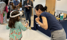 A young participant experiencing virtual reality for the first time at the 2023 Georgia Tech Science and Engineering Day.