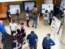 Students and faculty gather for a Research Experience for Undergraduates poster session. (Photo Renay San Miguel).jpg